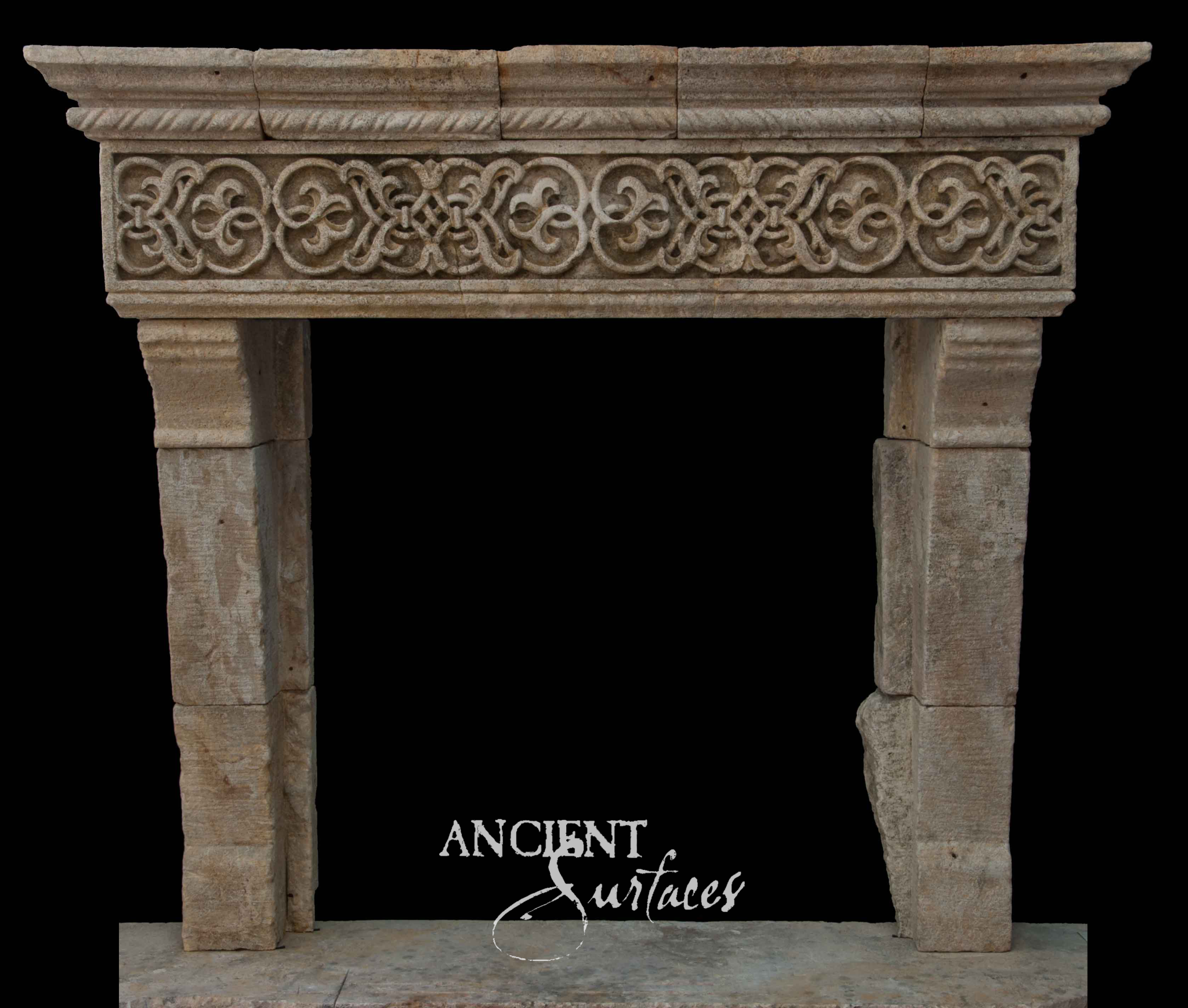 Reclaimed limestone fireplace mantel carved with an interlaced strapwork frieze and cable molding above tapered jambs built from stacked stone blocks