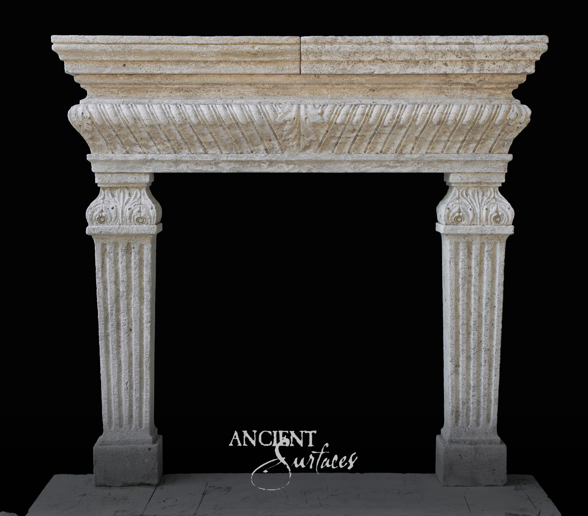 Reclaimed limestone fireplace mantel with a coved frieze carved in diagonal gadrooning above slim fluted columns with acanthus capitals
