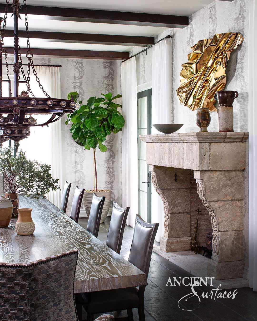 Rustic reclaimed limestone fireplace mantel with a thick layered shelf and broad foliate carved console corbels curving down to full height jambs