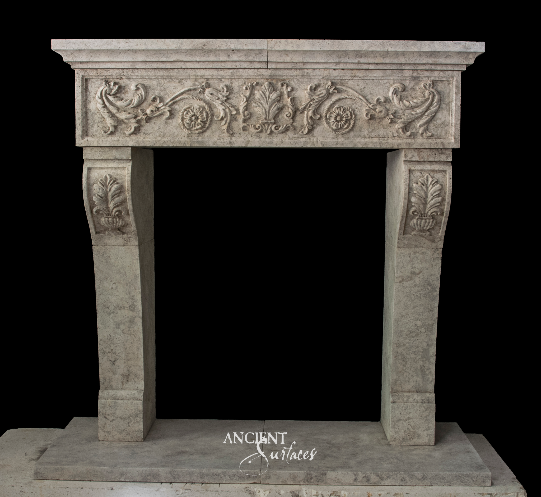 Grey reclaimed limestone fireplace mantel with a recessed frieze carved in scrolling vine and a central palmette, above tapering jambs with carved leaf and urn panels